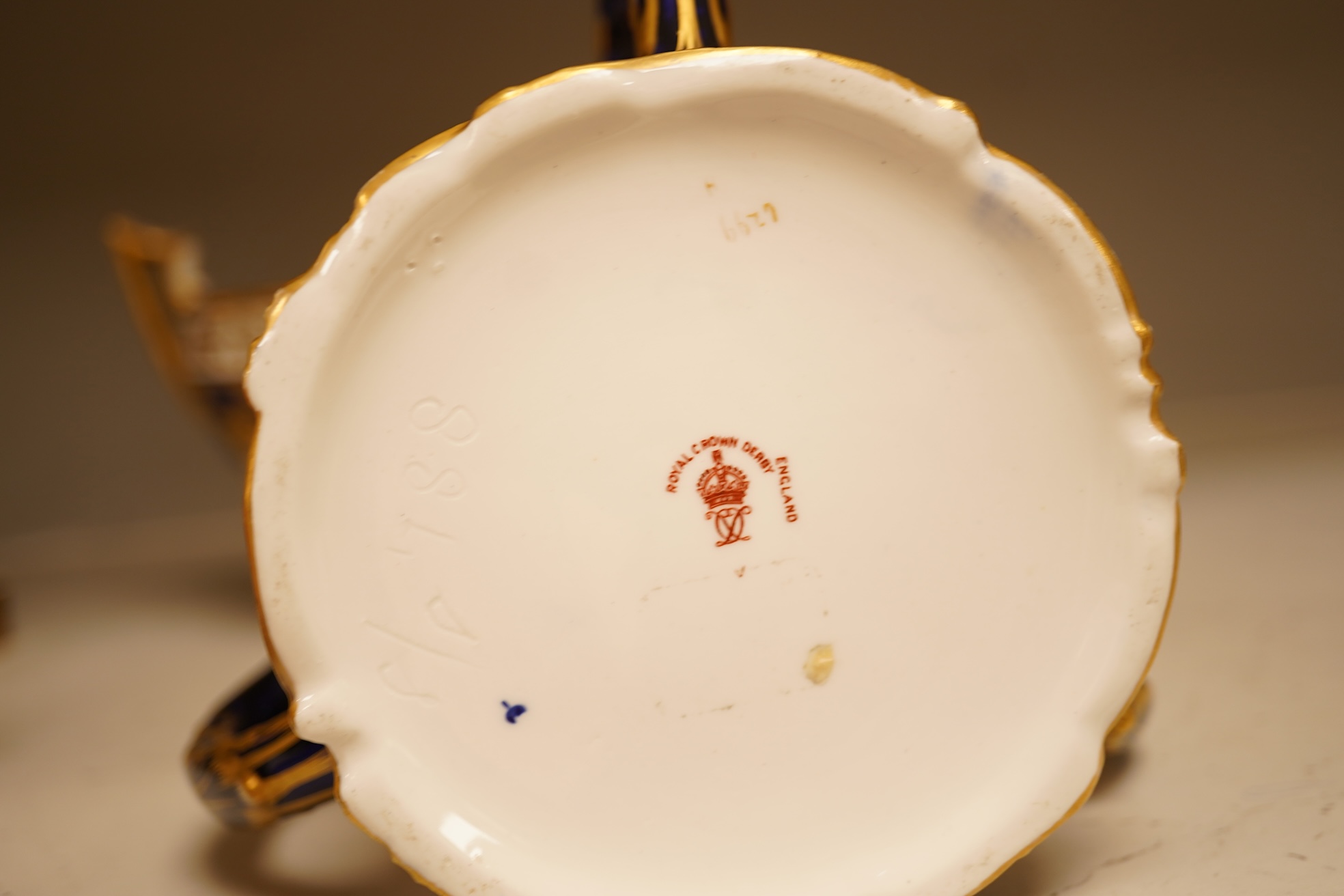 A collection of Royal Crown Derby, to include a two handled bowl, a fluted pedestal vase, saucer with landscape central cartouche etc (5). Vase 19cm high.